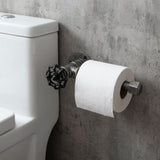 Ścienny uchwyt na papier toaletowy z żeliwa czarnego z pokrętłem, zamontowany obok WC