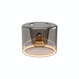 Żarówka LED donut E27 z przydymionego szkła, Ø 120 mm, włączona, ciepły pierścień światła, białe tło